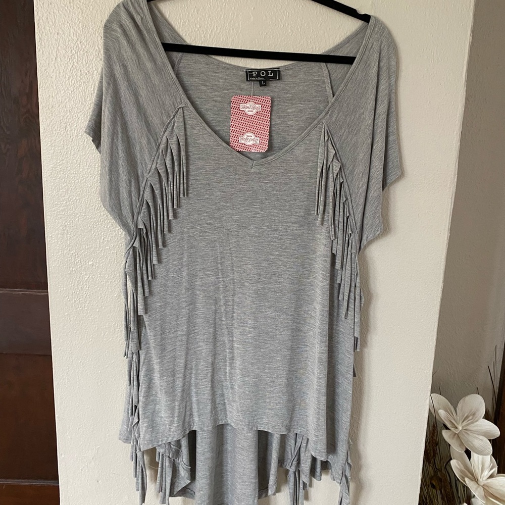Women’s Boutique top. Very Unique. Ling length. Fringe. NWT
